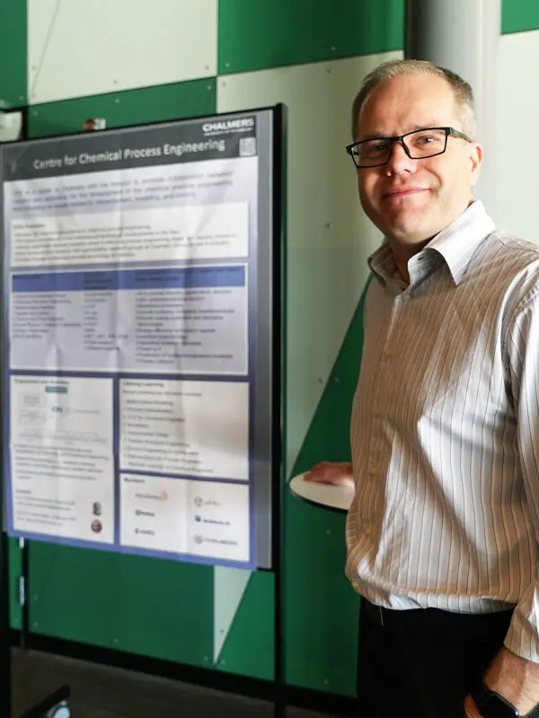 Man standing in front of a poster board