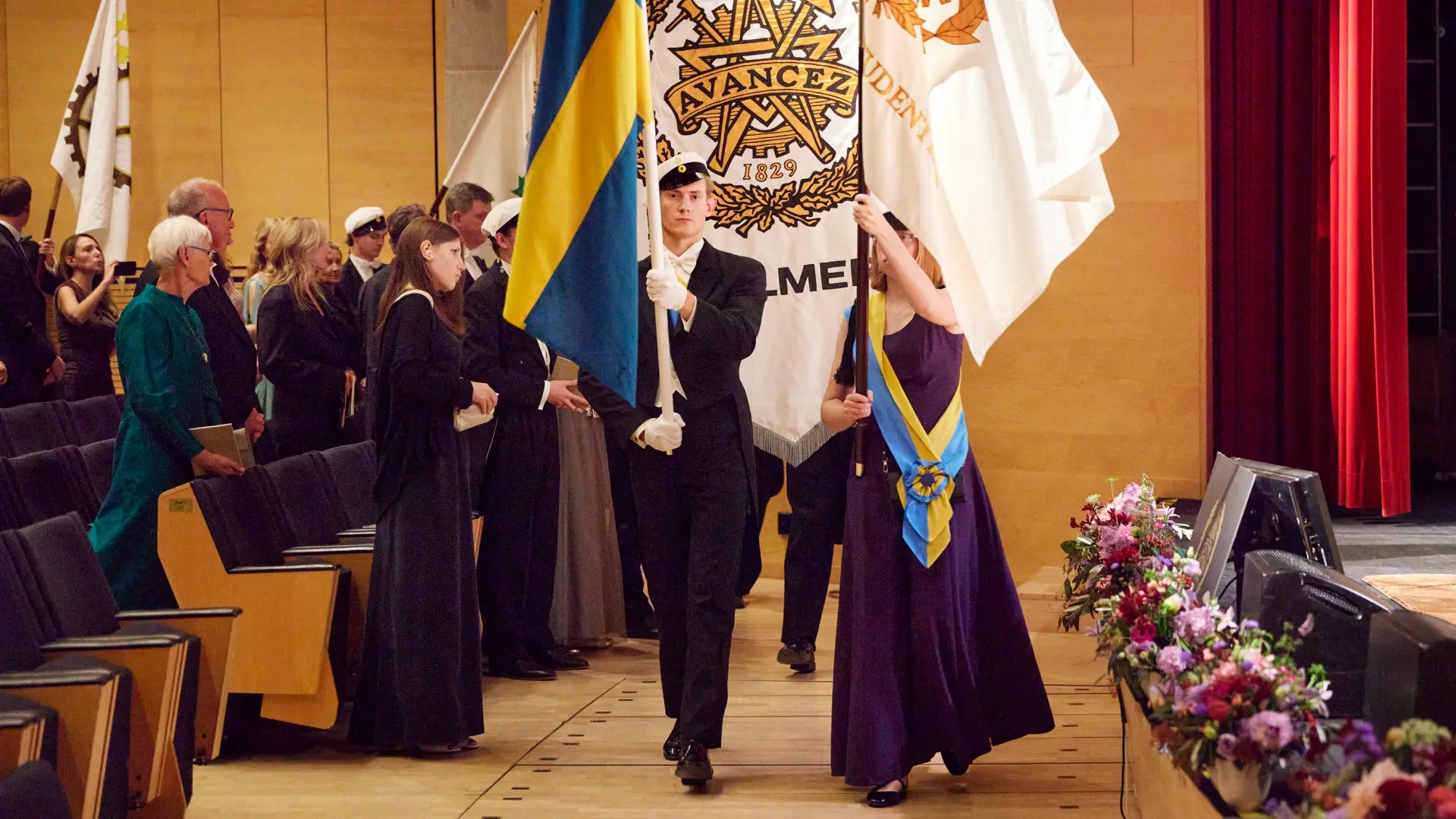 Students in marching parade with flags in their hands