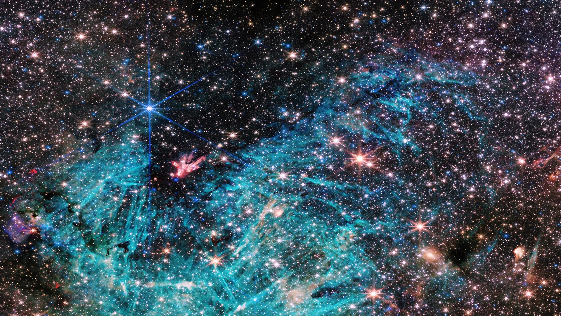 Stjärnor mot svart bakgrund, med gasmoln som visas i turkos